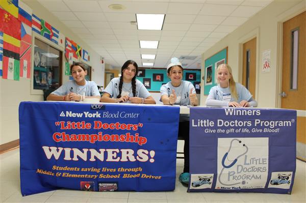 students at table for blood drive  